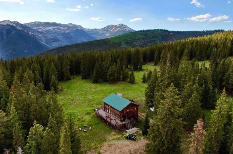 Off-grid mountain retreat cabin surrounded by forest with stunning Colorado mountain views, luxury lodge for sale near Gunnison.