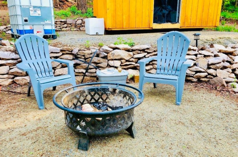 Mountain RV lot with fire pit, Adirondack chairs, and storage shed in Arrowhead Subdivision, Cimarron, Colorado.