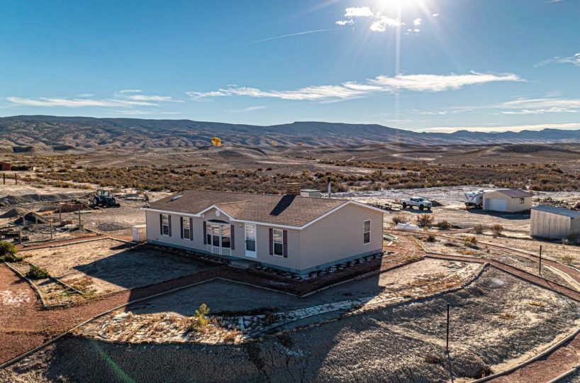 Spacious manufactured home on 80-acre rural property in Delta, Colorado with panoramic mountain views and expansive desert landscape.