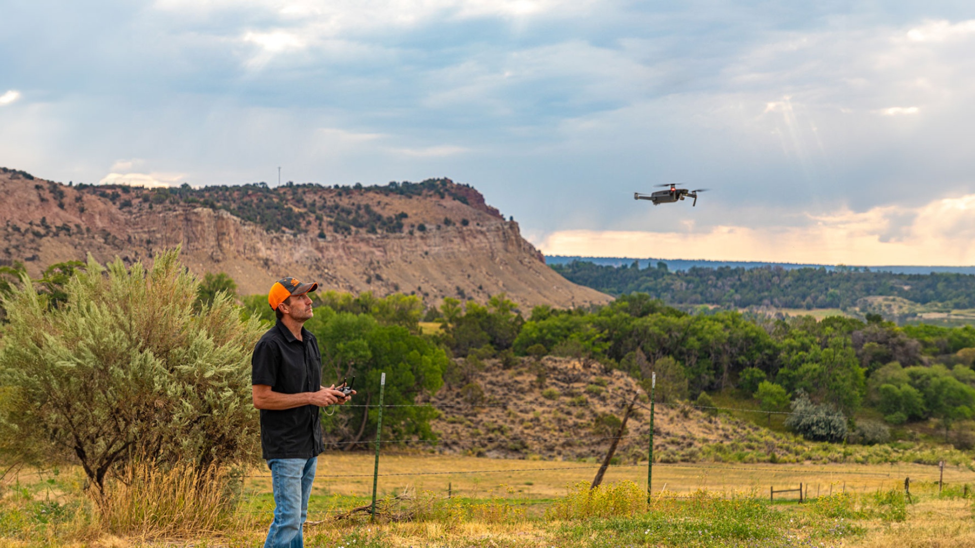Broker Robert Gash, a licensed drone pilot flying a drone over scenic Western Colorado landscape for real estate video marketing, capturing aerial views of properties for sale.