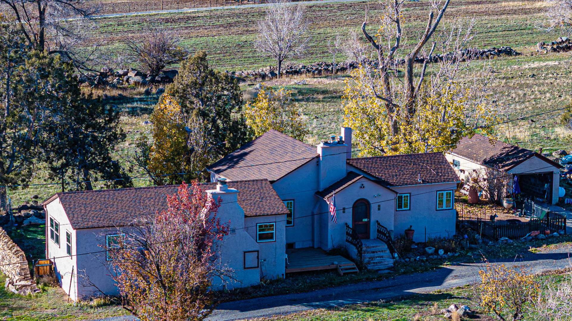 Home on 15 acres at 794 NE Indian Camp Ave in Western Colorado, featuring irrigated pasture, mature trees, and rural surroundings.